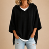 Knitted hooded poncho with three-quarter sleeves