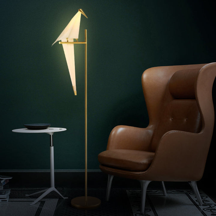 "Elegant wireless origami bird lamp with magnetic attachment emitting warm light; enhances home decor with artistic design."