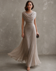 Draped sleeveless maxi dress with flowing floor-length skirt